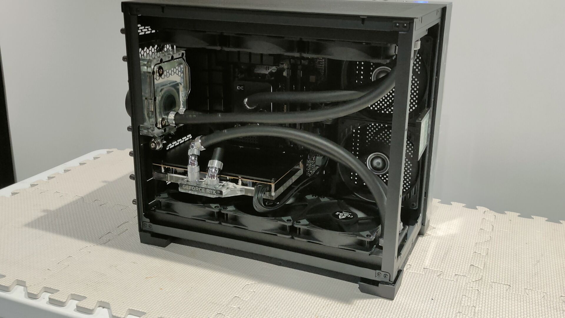 Unedited January 2024 open-side photograph of David's black PC showing its real water-cooling loop