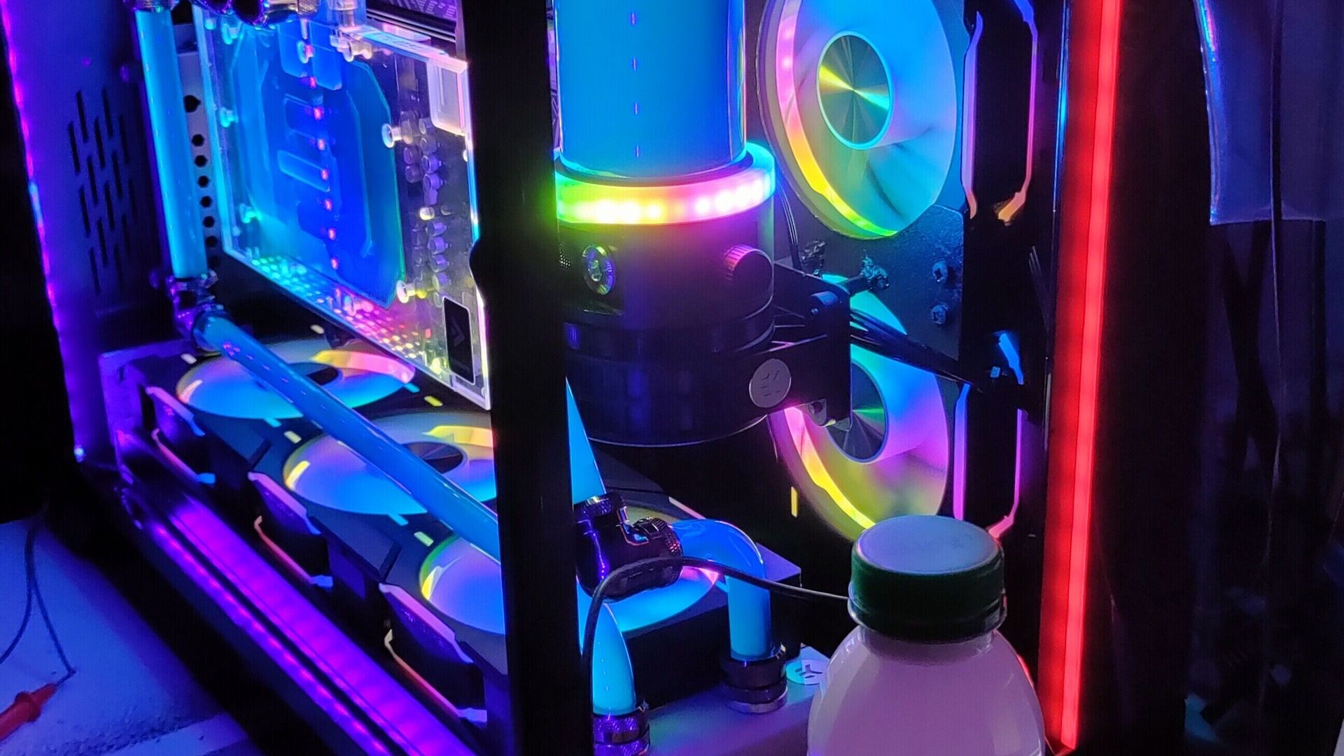 Close view of Edmond's hardline water-cooling tubes, pump and illuminated PC components