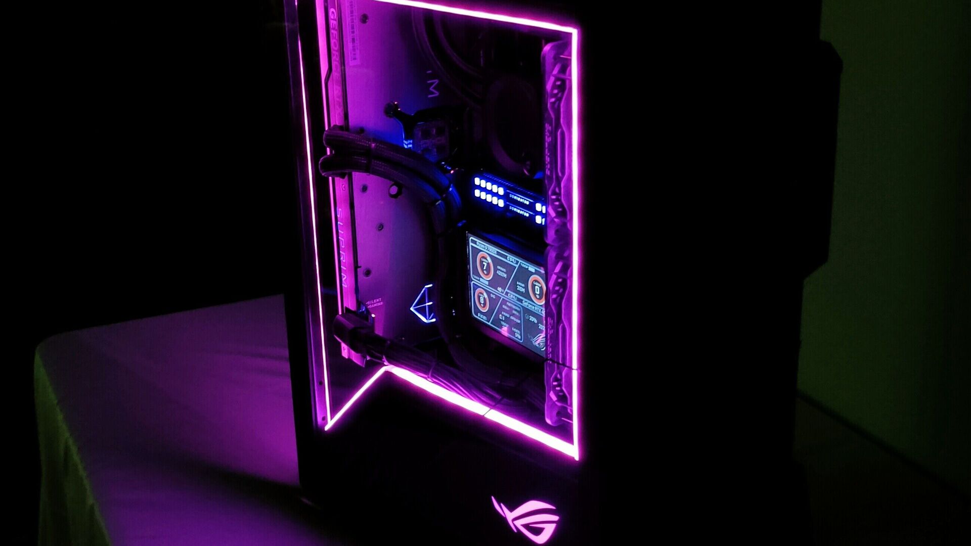 Original photograph showing Sean's magenta-lit ROG Z11 and internal status display